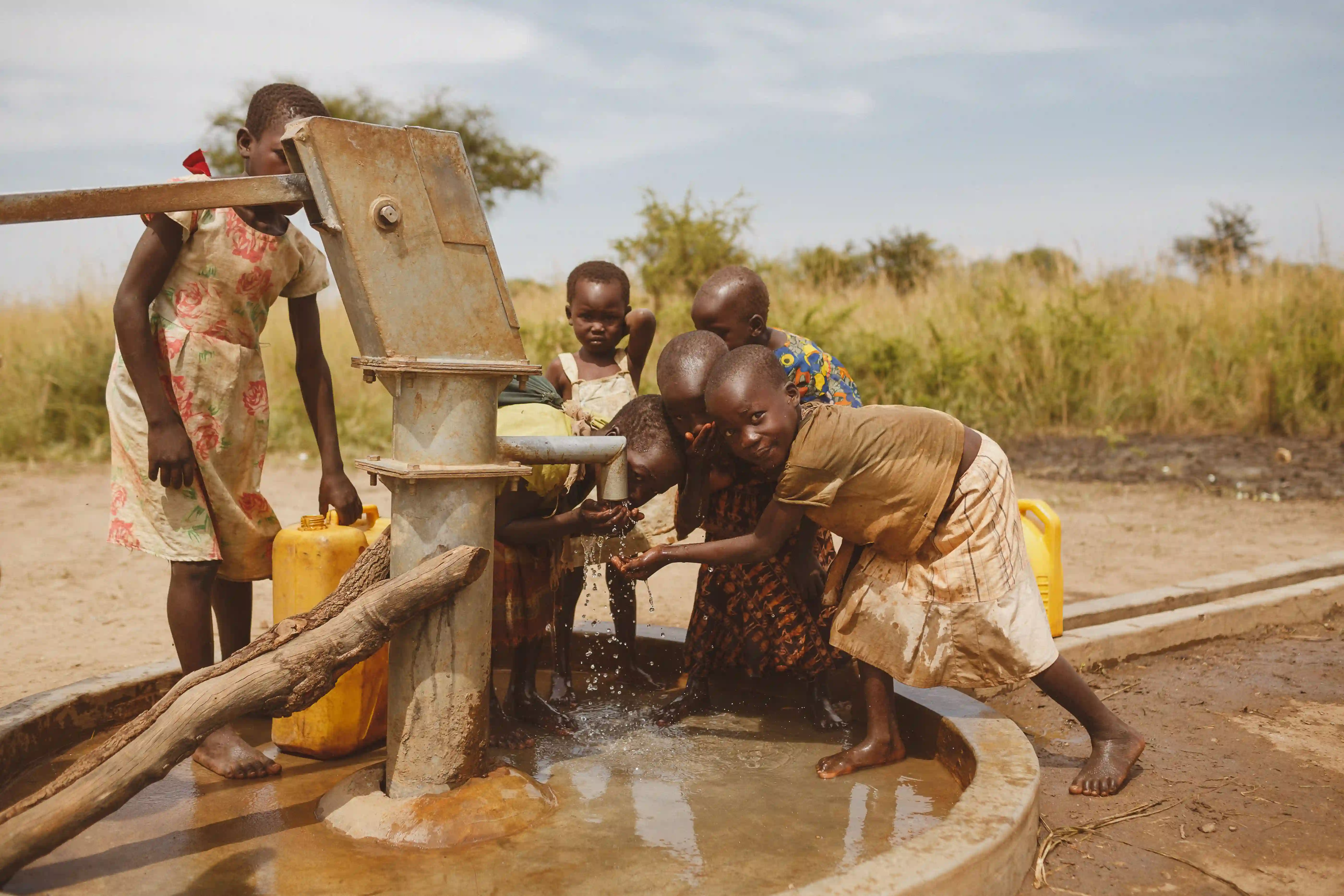 African children gathered around clean water